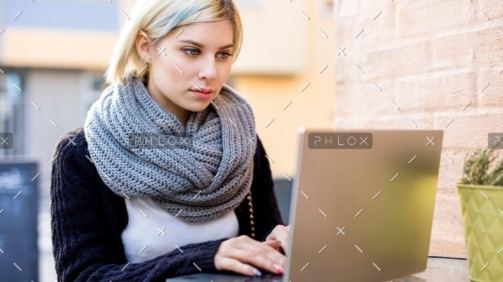 demo-attachment-40-young-focused-woman-working-on-laptop-at-outdoor-PTTFVNE